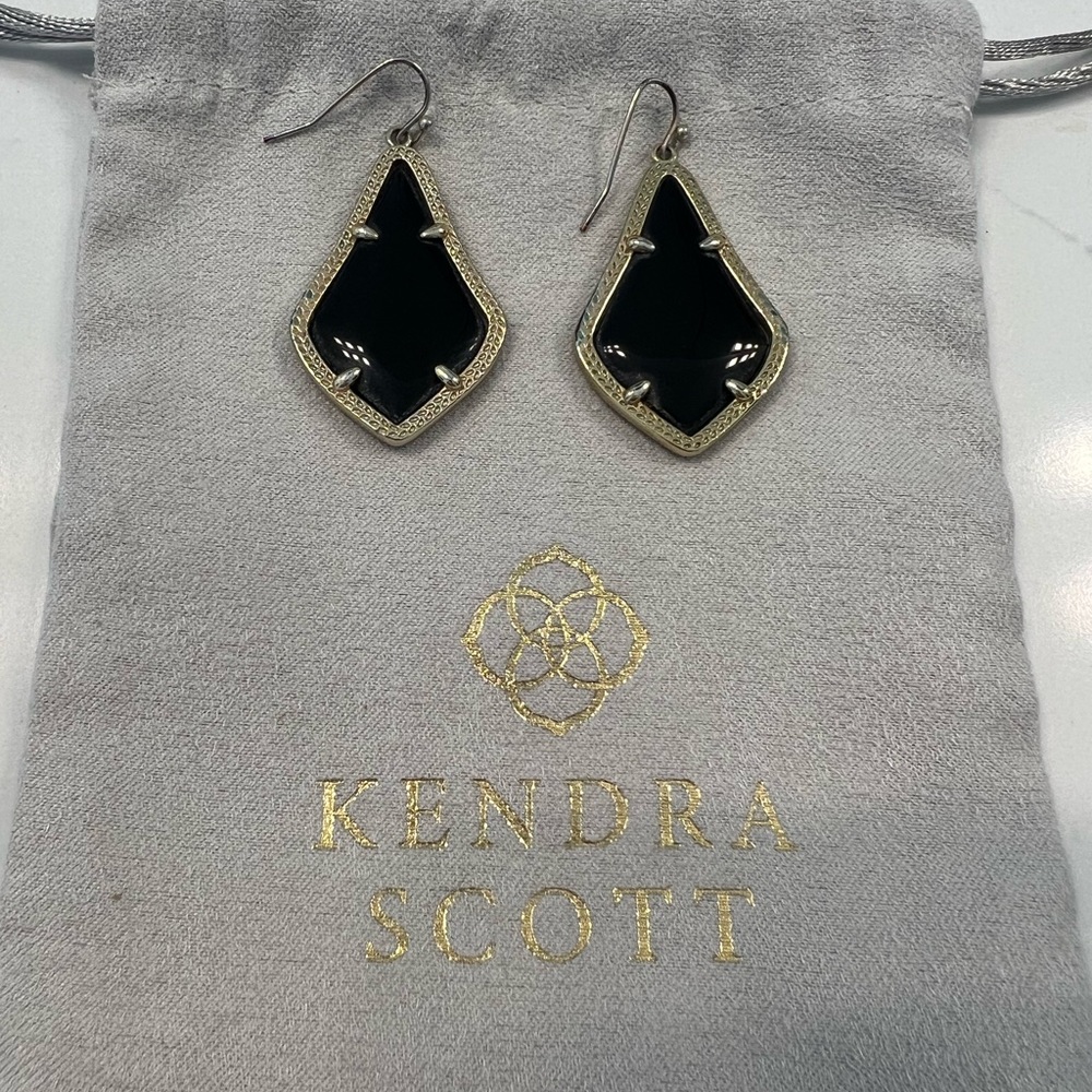Kendra Scott black gold earrings.